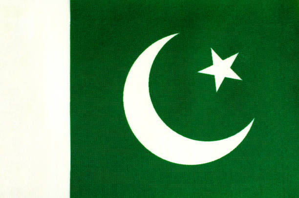 fabric-based national flag of Pakistan close-up fabric-based national flag of Pakistan close-up pakistani flag stock pictures, royalty-free photos & images
