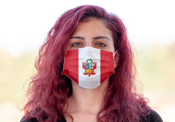 A portrait of a young woman wearing a face mask with Ğeruvian flag design because of new coronavirus (Covid-19) pandemic. Taken via medium format camera. Flag made in Adobe Illustrator CC