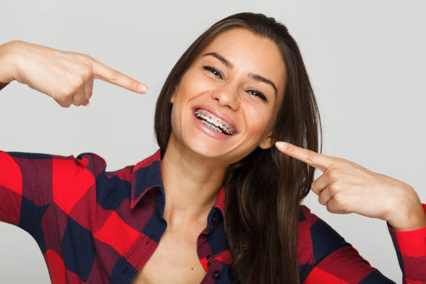 Face of a young woman with braces on her teeth stock photo