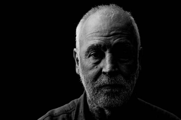 Face of an old man in black and white. stock photo