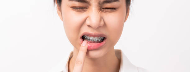Face of asian woman finger touches a toothache maybe because of poor care. stock photo