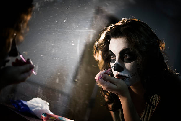 Face paining Woman painting face for Halloween night party acting performance stock pictures, royalty-free photos & images