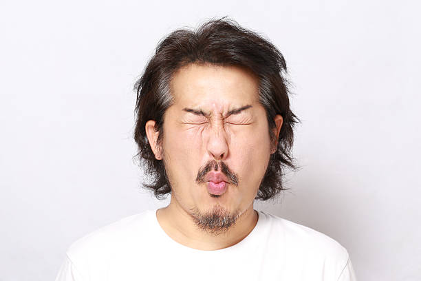 Face The portrait of Asian man. sour taste stock pictures, royalty-free photos & images