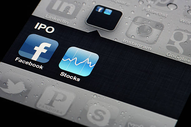 Facebook and Stocks Apps - iPhone 4 stock photo