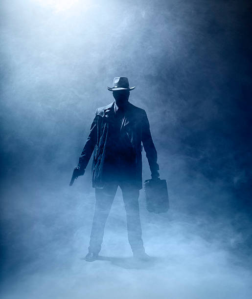 Faceless Killer Faceles man with a gun and a briefcase standing in the fog. Smoking Kills stock pictures, royalty-free photos & images