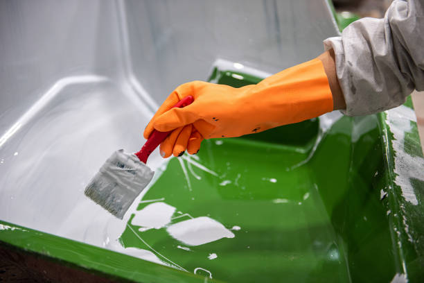 Factory worker brushing solution on fibreglass mold Hand of a chemical factory worker in a rubber glove painting solution on a mold fibreglass stock pictures, royalty-free photos & images