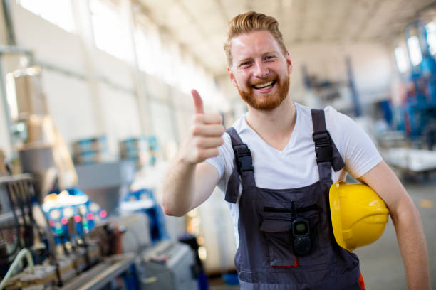 Factory worker holding thumbs up stock photo