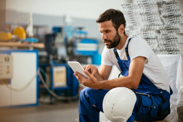 Factory worker using tablet stock photo