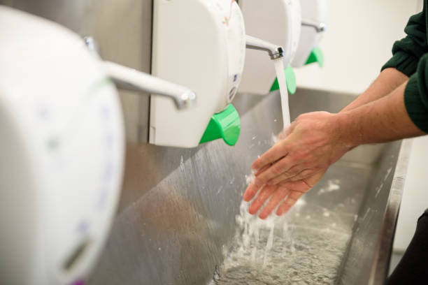 Factory worker washing hands stock photo