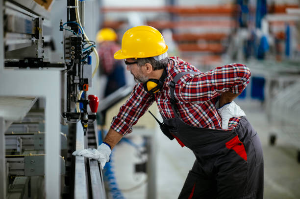 Factory worker with painful back injury stock photo stock photo