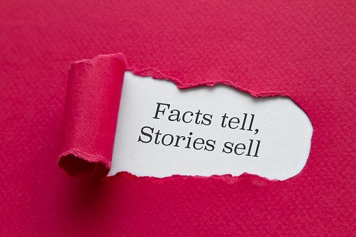 Facts tell, stories sell word written under torn paper.