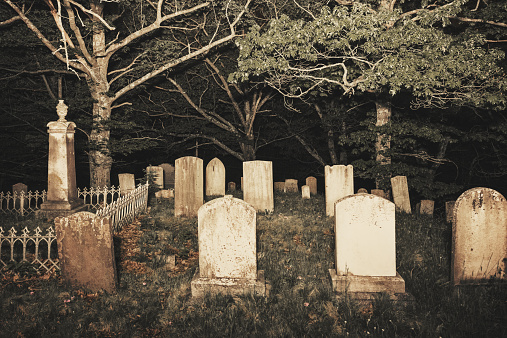 A 19th century rural cemetery late at night. Long exposure with light painting.