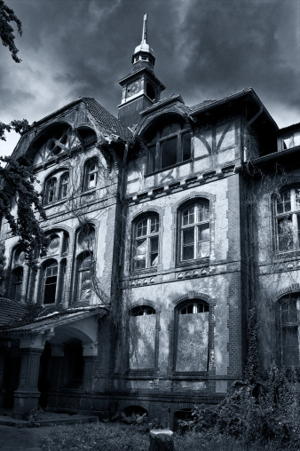 Faeade Of A Large Haunted House In Gray And Blue Tones Stock Photo