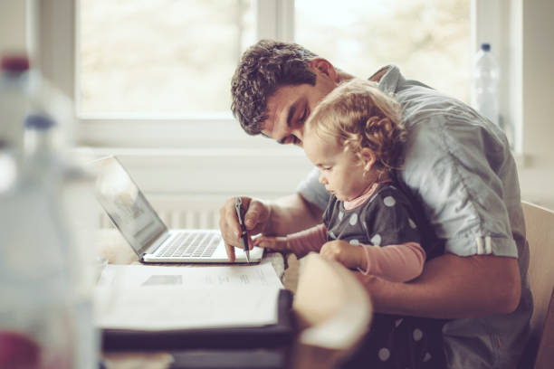 Fahter is showing his daughter things on a laptop Fahter is showing his daughter things on a laptop home finances photos stock pictures, royalty-free photos & images