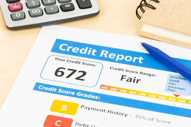 Fair credit score report with pen and calculator; document and the report are mocked-up stock photo