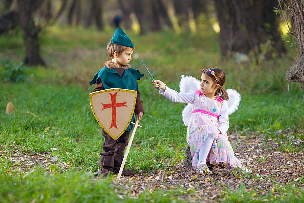 Fairy and Knight Cute little children dressed up as a fairy and a knight playing in a forest period costume stock pictures, royalty-free photos & images