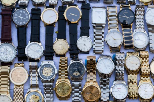 Fake Counterfeit Wristwatch Bangkok Thailand Bangkok: Fake and counterfeit wristwatches are a common site in the local street market stalls of Bangkok, Thailand. brand name stock pictures, royalty-free photos & images