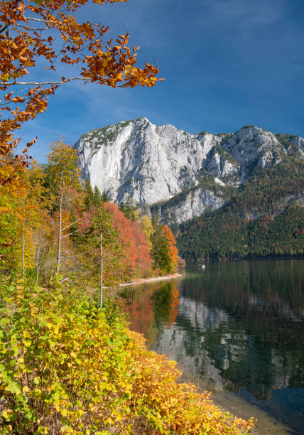 Fall Reflections - Lake Altaussee, Styria, Austria The beautiful lake Altaussee on this stunning autumn day. Austrian Alps Panorama. You can see the Mountain Trisselwand in back. Converted from RAW. ausseerland stock pictures, royalty-free photos & images