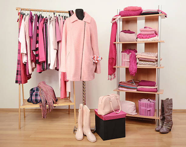 Fall winter wardrobe full of all shades of pink clothes. stock photo
