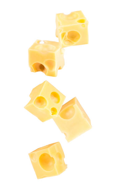 Falling cubes of cheese isolated on white stock photo