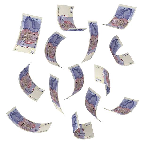 Falling money - British pounds stock photo