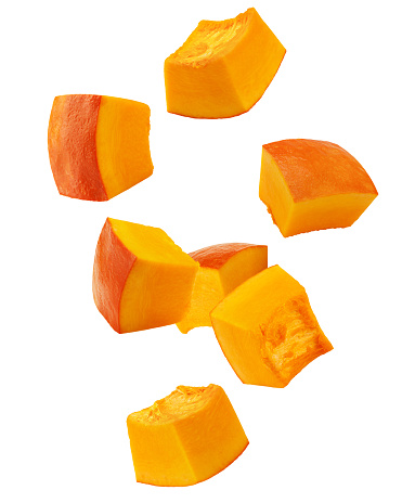 Falling piece of pumpkin, cubes, isolated on white background, clipping path, full depth of field