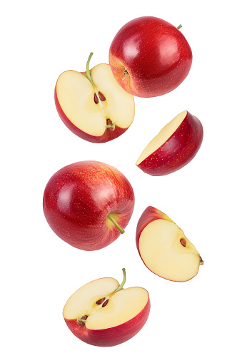 falling Red apple slices isolated on white background