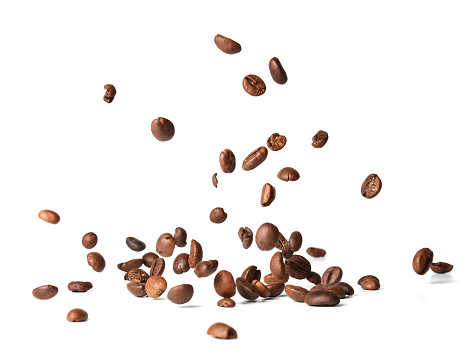 Falling roasted coffee beans. Chaotic motion. White isolated background.