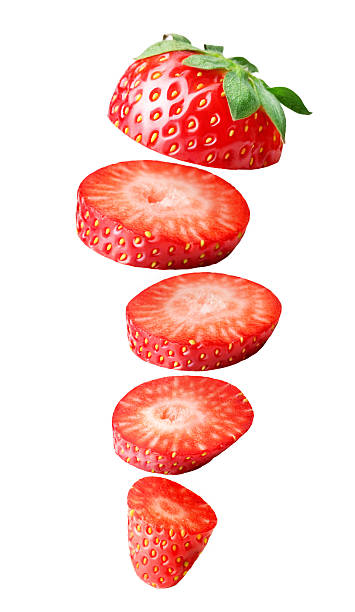 Falling sliced strawberry isolated on white stock photo
