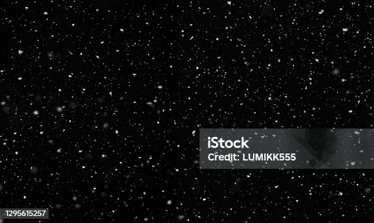 istock Falling snow isolated on black background. 1295615257