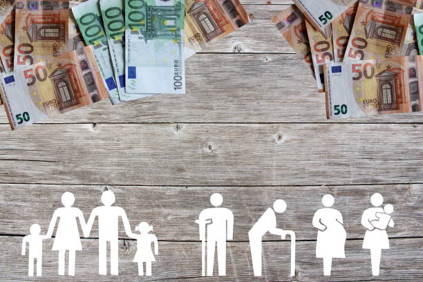 Family and Weak social categories welfare concept with euro banknotes on wooden background stock photo