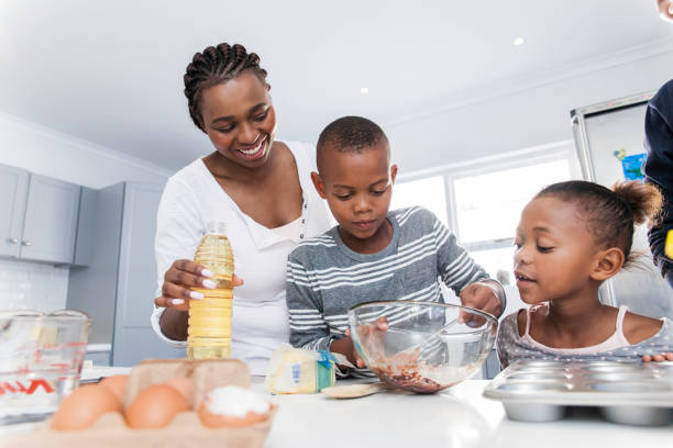 Family baking muffins together. stock photo