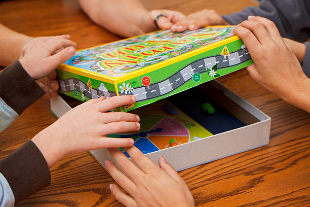 Family Choosing Board Games To Play stock photo