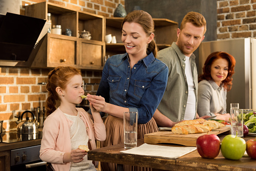 Family Cooking Dinner At Home Stock Photo - Download Image Now - iStock