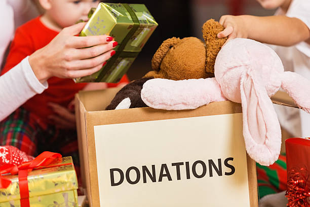 família presentes e brinquedos para doação de caridade de natal de férias - woman holding a christmas gift imagens e fotografias de stock