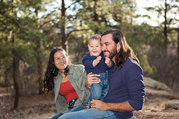 Family enjoying a day in nature "Young family enjoying a day in nature, shallow DOF, father and son in focus" indigenous peoples of the americas stock pictures, royalty-free photos & images