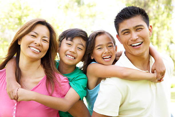 Family Enjoying Day In Park  filipino ethnicity stock pictures, royalty-free photos & images