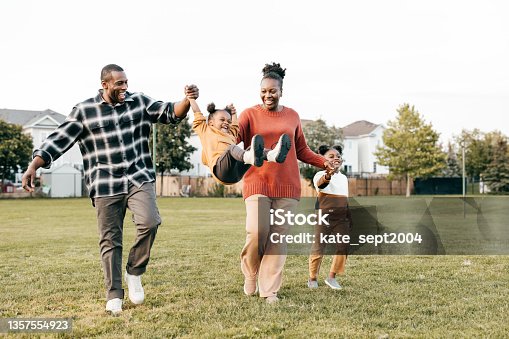 istock Family enjoying springtime outdoors with kids 1357554923