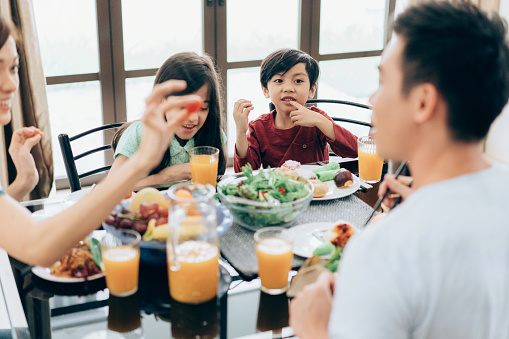 Family Enjoys The Meal Lunch Together Stock Photo - Download Image Now
