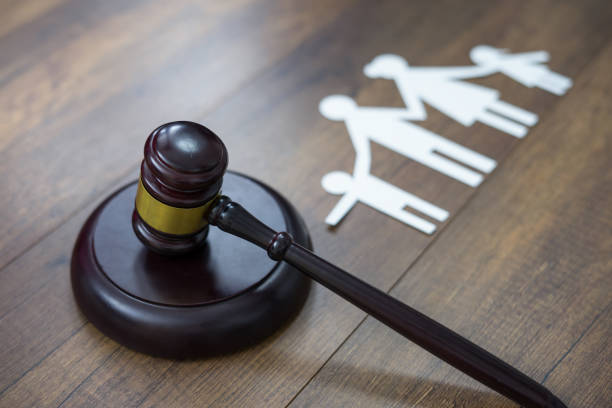 Family figure and gavel on table. Family law concept stock photo