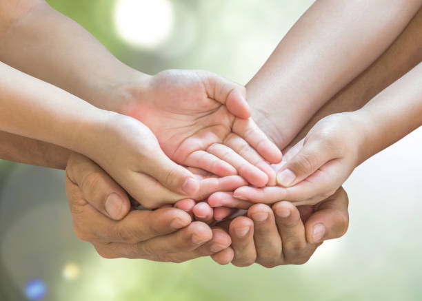 family hands praying together (clipping path) for donation charity concept - hands family imagens e fotografias de stock