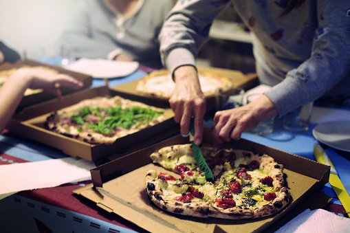 Family Having Dinner Take Away Pizza Stock Photo - Download Image Now