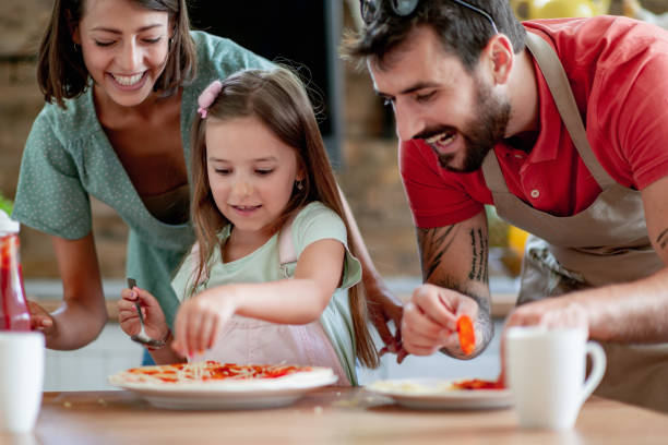 Family having fun in kitchen stock photo