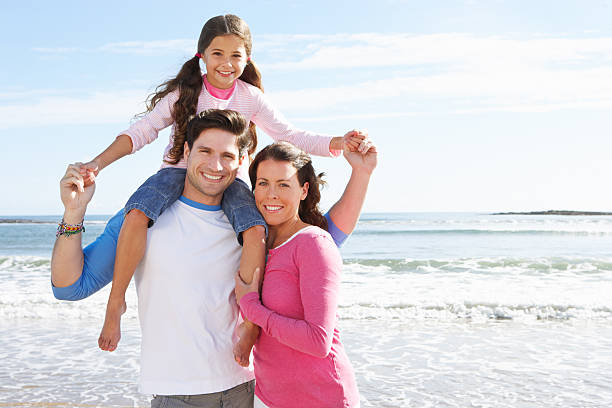 Family Having Fun On Beach Holiday stock photo
