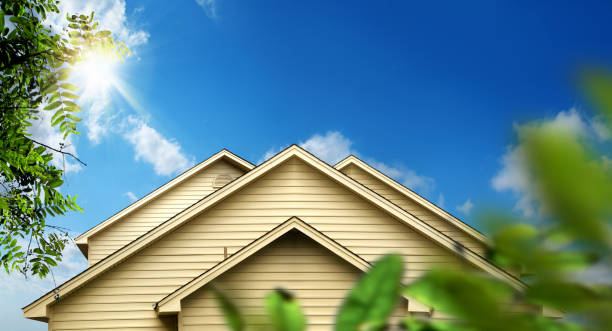 family home exterior over sunny blue sky stock photo