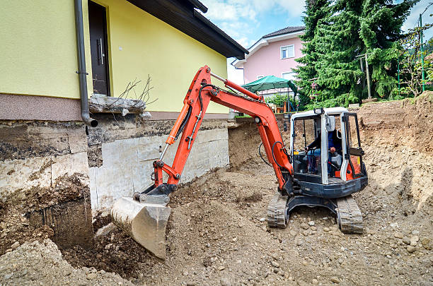 Family house is being rebuilt with the help of excavator stock photo