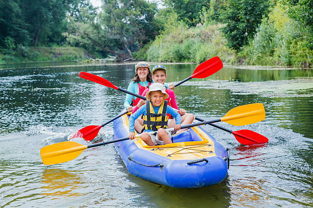 Family kayaking on the river stock photo