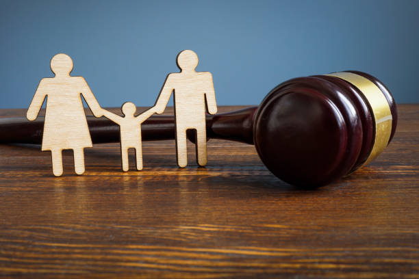 Family law and adoption concept. Figures and gavel. stock photo