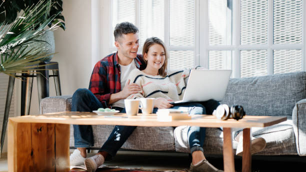 Family life. Couple at home with laptop stock photo