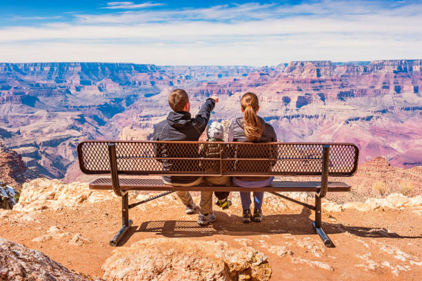 Family looking at view Grand Canyon National Park USA Stock photograph of a family with one child looking at view in Grand Canyon National Park, South Rim, USA on a sunny day. south rim stock pictures, royalty-free photos & images